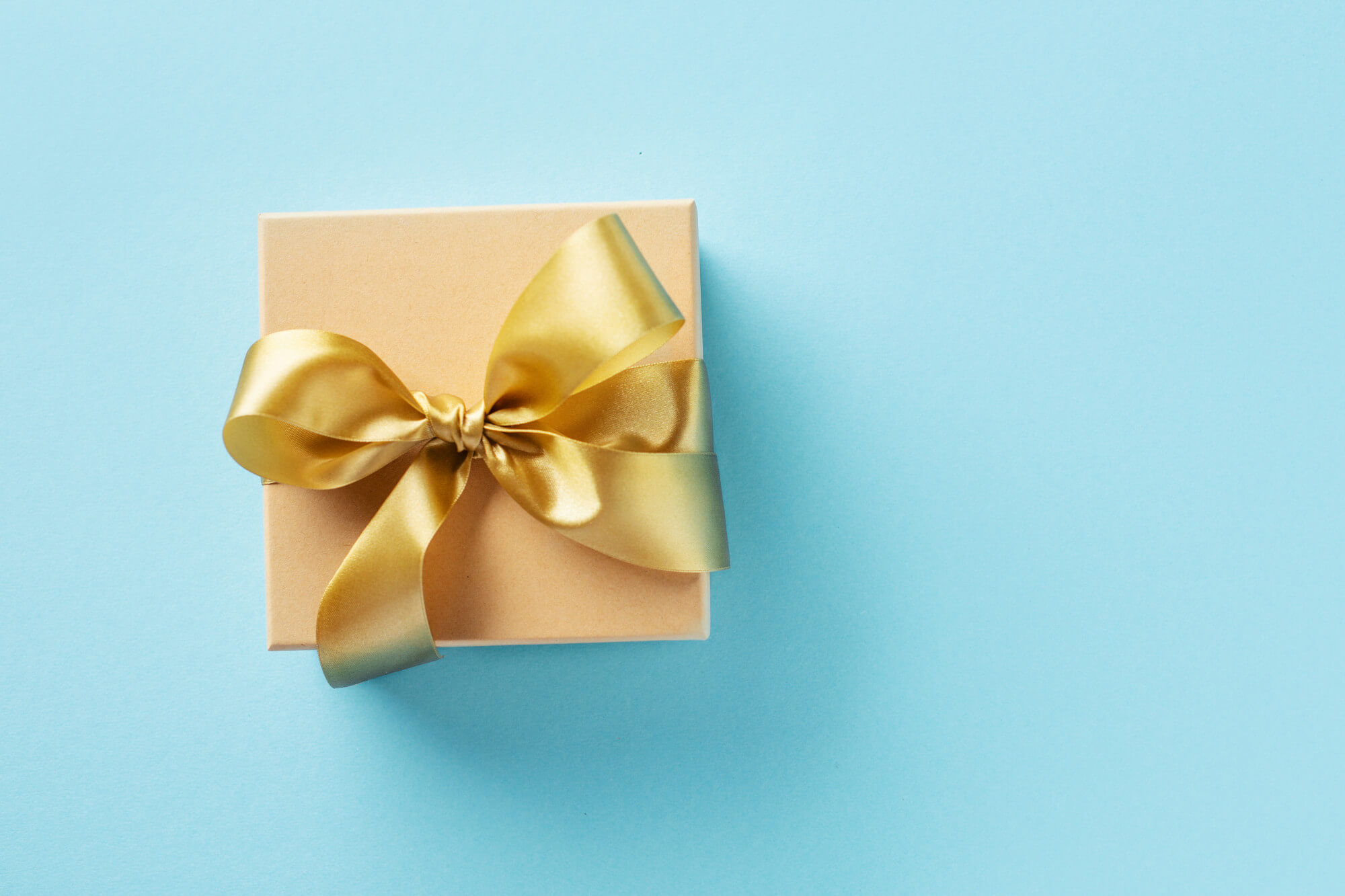 gift-box-with-golden-ribbon-bright-background